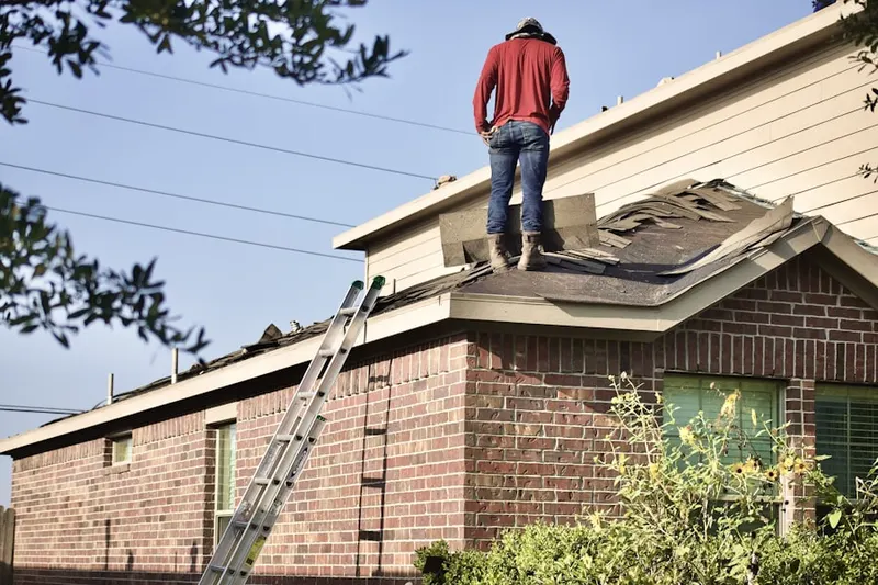 Professional roofer working on a residential roof in Lake Pointe